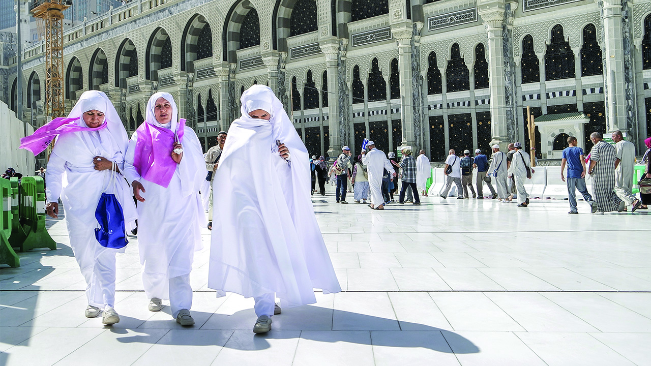 Women in Saudi Arabia walk through city.