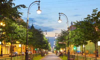 A beautiful city street lined with trees on both sides.