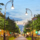A beautiful city street lined with trees on both sides.