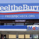 A billboard above a gas station that reads "Feel The Burn," actually promotes free STD testing.