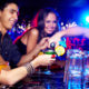 Picture of young adults drinking cocktails at a bar.