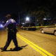 Photo of a police spreading crime tape