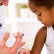Photo of a young girl receiving a vaccine shot