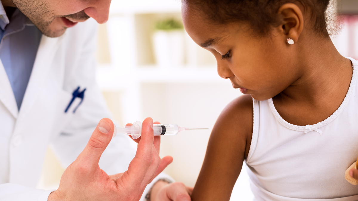 Photo of a young girl receiving a vaccine shot