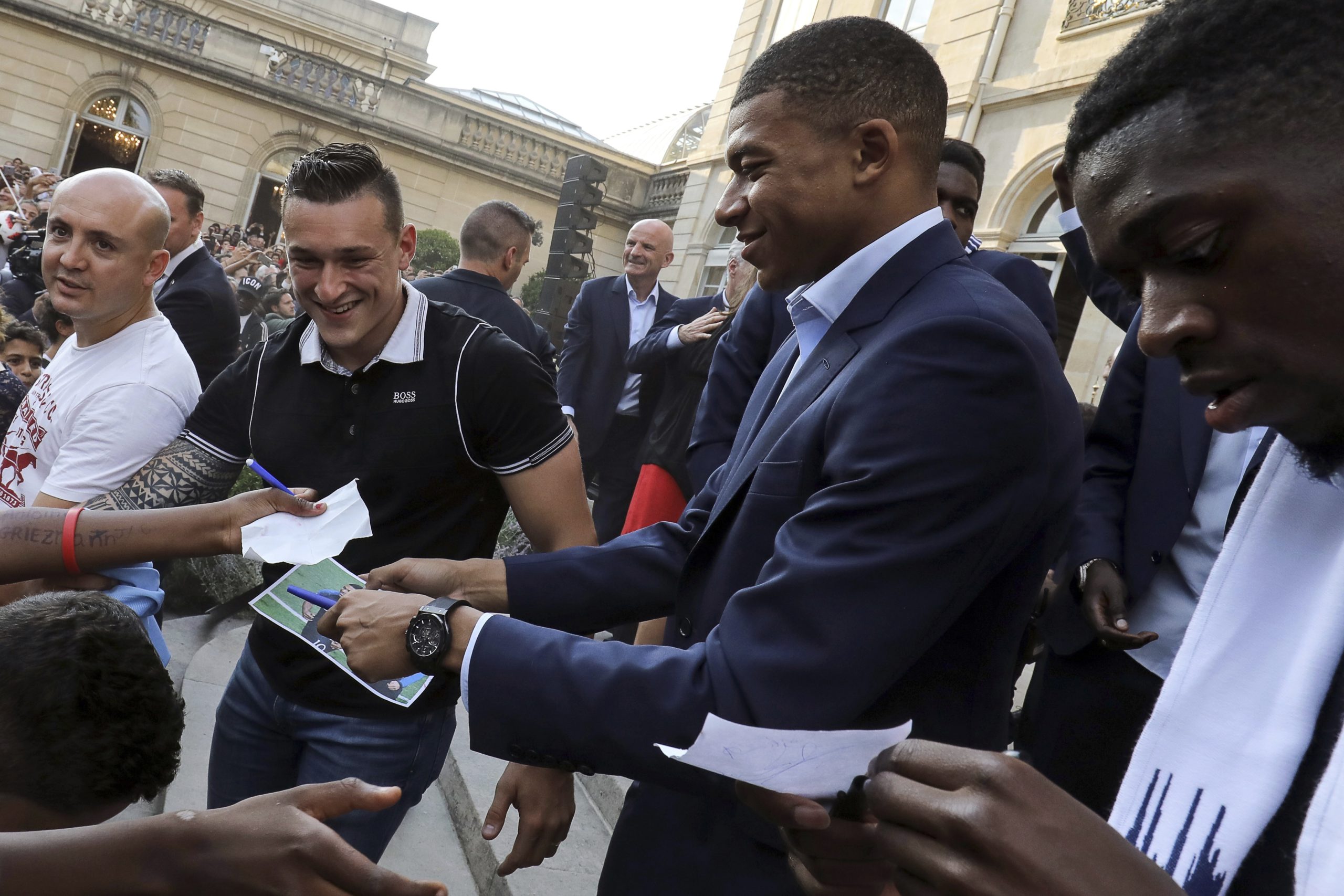 Photo of two French World Cup team members signing autographs