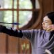 Photo of a girl scout releasing an arrow during archery session
