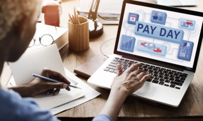 Photo of man paying bills via computer on payday