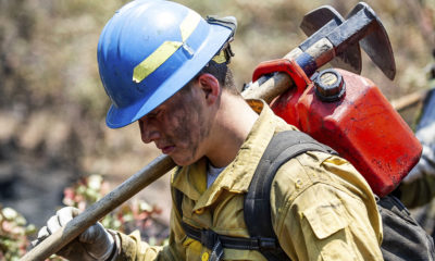Photo of a "hot shot" firefighter carrying his gear