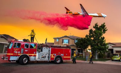 Photo of a plane dropping fire retardant