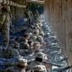 Photo of Army drill sergeants standing over recruits