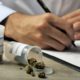 Photo of doctor writing a prescription for medical marijuana