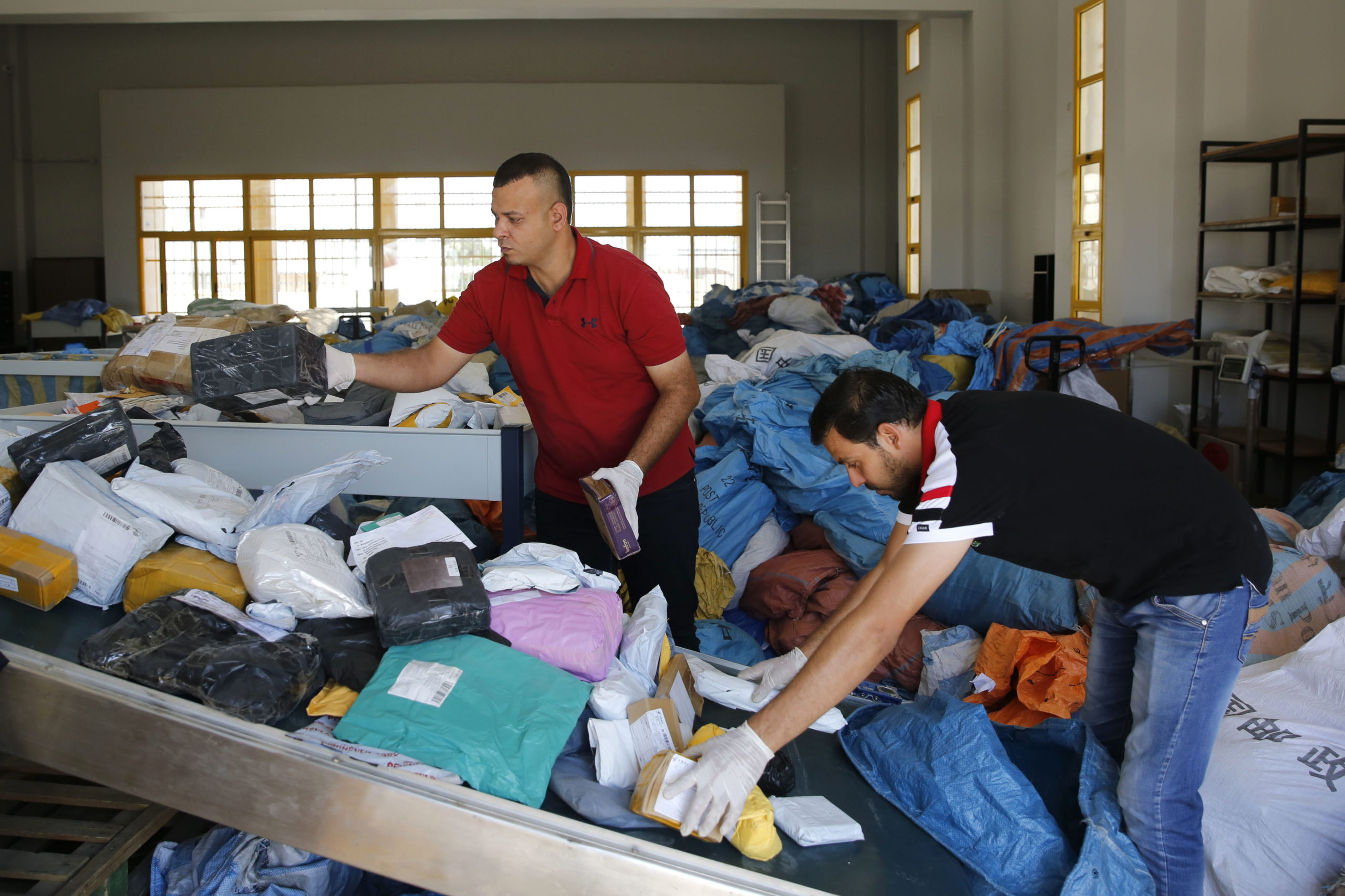 Palestinian postal workers sort through 8 years of mail held by Israel.