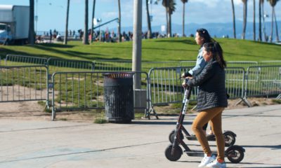 Photo of two girls riding motorized scooters in Venice