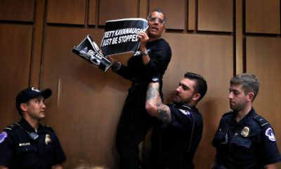 A protester is lifted off of a chair by U.S. Capitol Police