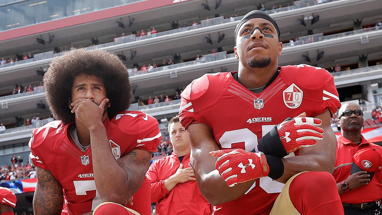 Photo of San Francisco 49ers quarterback Colin Kaepernick, left, and safety Eric Reid