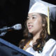 Fresno Unified School District Graduate in cap and gown speaking at commencement.