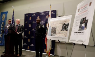 Photo of LAPD Capt. Billy Hayes fielding questions during a press conference