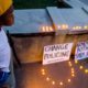 Photo of Solomon Grayson, 6, stands on a ledge next to a memorial