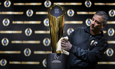 Photo of Charley Green buffing the NCAA college football championship trophy