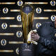 Photo of Charley Green buffing the NCAA college football championship trophy