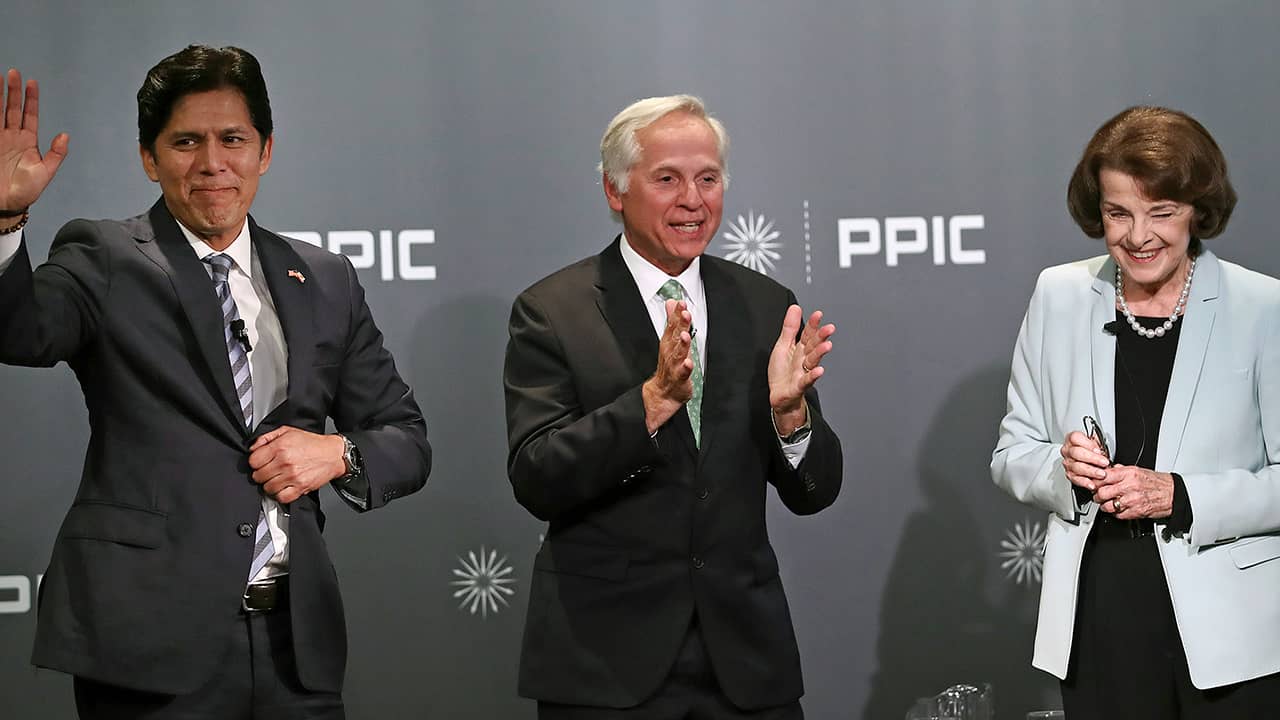 Photo of Kevin de Leon, debate monitor Mark Baldassare, and Dianne Feinstein