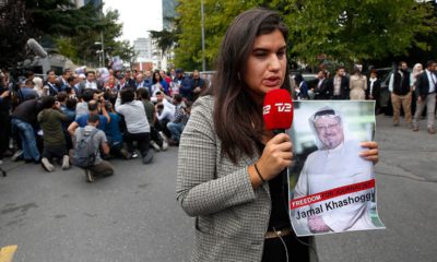 Photo of journalist holding a poster of missing Saudi writer Jamal Khashoggi
