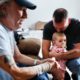Tom Wolikow, right, holds his daughter Annabella alongside his father John