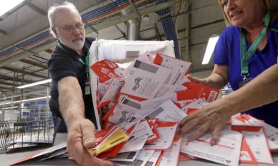 Photo of election workers dumping ballots collected from drop boxes