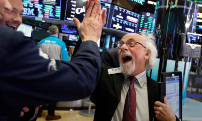 Photo of Wall Street floor traders exchanging high-fives