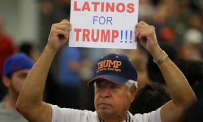 Photo of a man holding up a sign for President Donald Trump