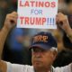 Photo of a man holding up a sign for President Donald Trump