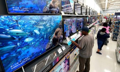 Photo of shoppers looking at televisions