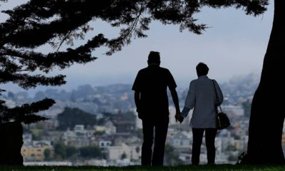 Photo of a man and woman walking under trees in San Francisco