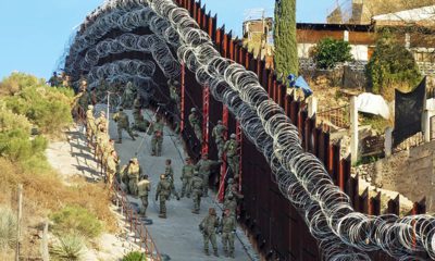 Photo of border wall in Arizona covered in razor wire