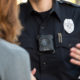 Photo of an officer with a body cam talking to a woman
