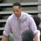 Photo of Jonathan Clark getting ready to slam dunk in a shirt and tie