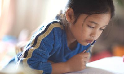 Photo of Asian American girl reading