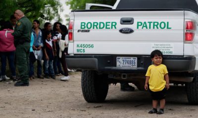 Photo of child waiting with other families that crossed the US-Mexico border
