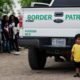 Photo of child waiting with other families that crossed the US-Mexico border
