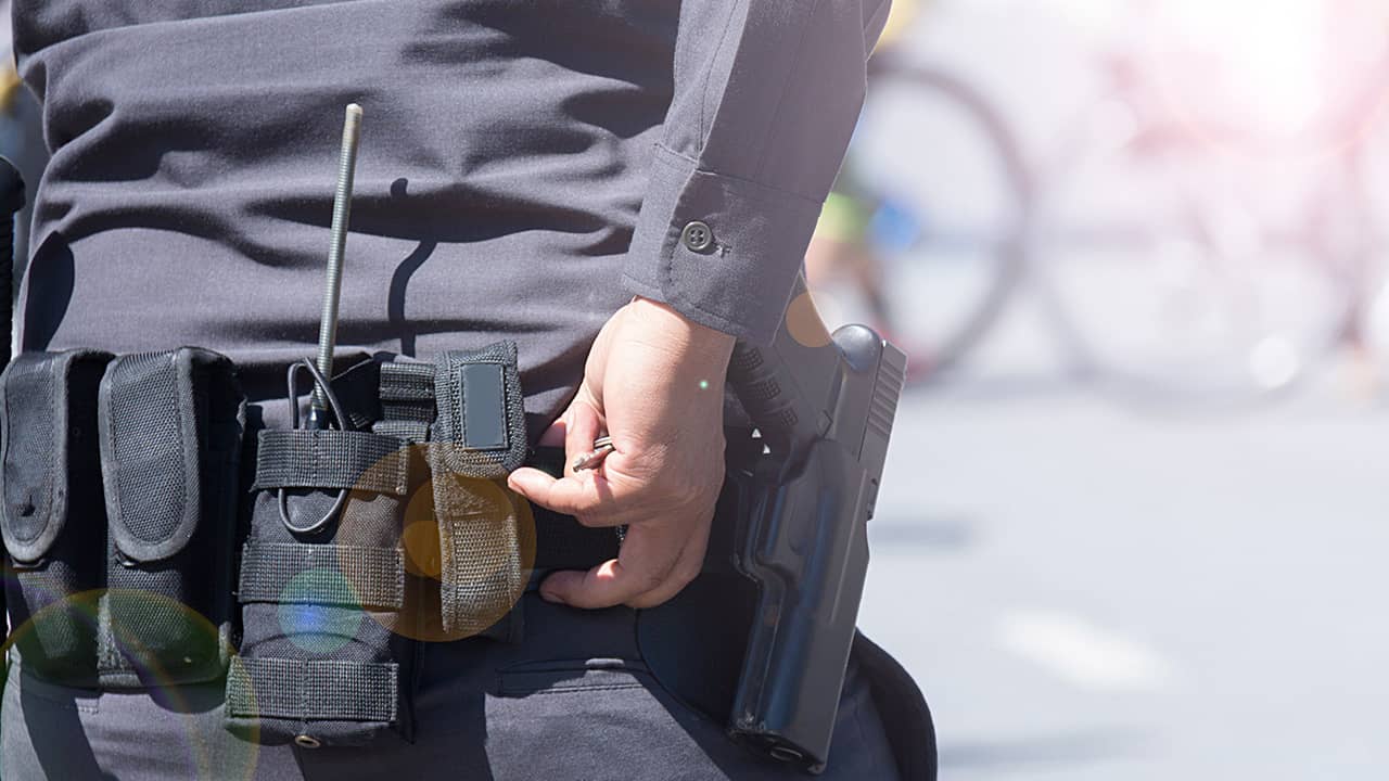 Photo of an officer ready to draw his gun