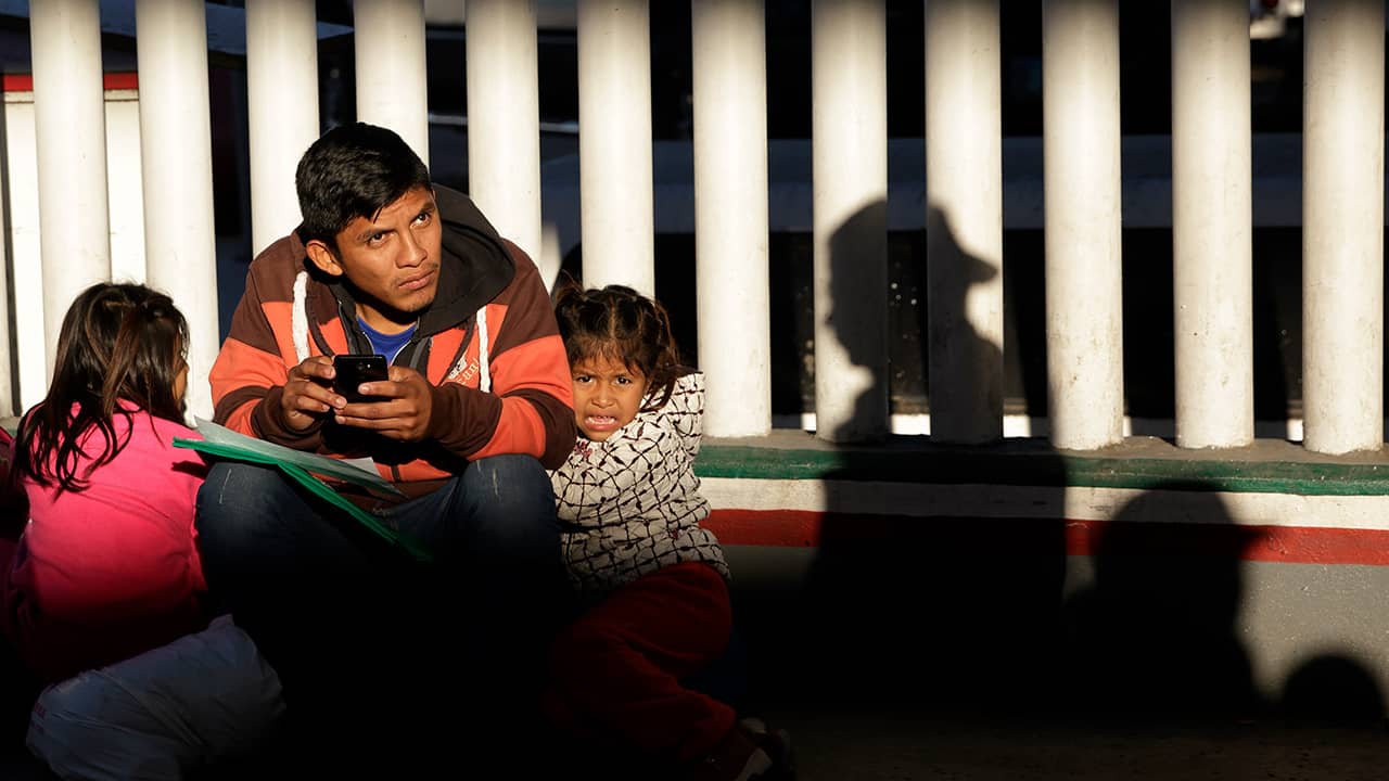 Photo of a migrant and his children