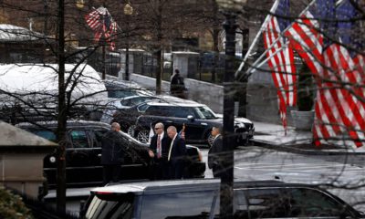 Photo of Secret Service Agents stand by the limo of VP Mike Pence