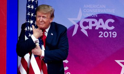 Photo of President Donald Trump hugging an American flag
