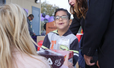 Photo of Tilley Elementary School student getting a new pair of tennis shoes from the nonprofit Shoes That Fit