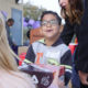 Photo of Tilley Elementary School student getting a new pair of tennis shoes from the nonprofit Shoes That Fit