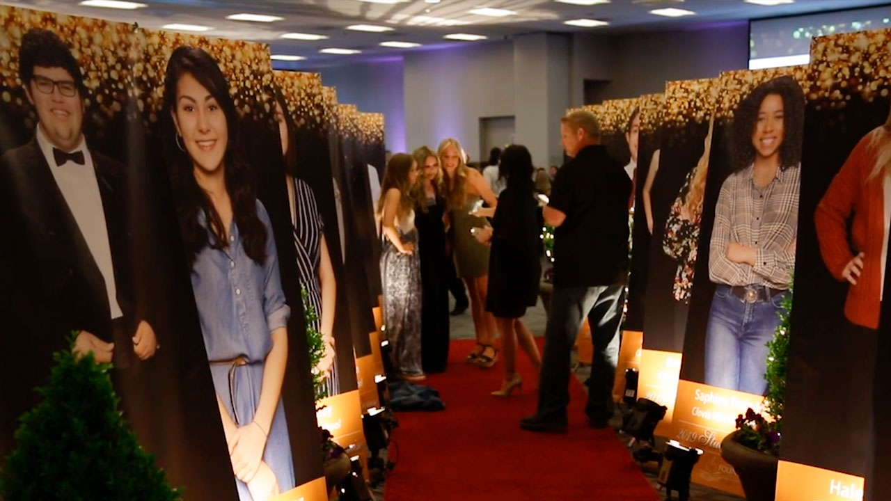 Photos of Clovis Unified Students of Promise on display at scholarship dinner event.
