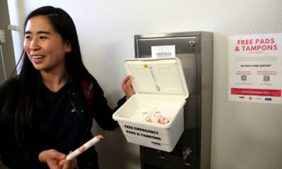 Photo of UC Davis student working to ensure placement of tampons and pads in UC Davis restrooms