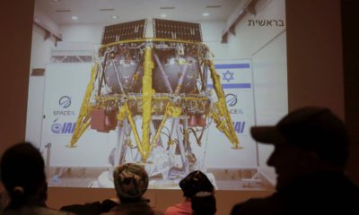 Photo of people watching a live broadcast of the SpaceL spacecraft