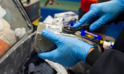 Photo of Transportation Security Adminstration (TSA) transport security officer Jon McKoy wiping an item