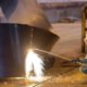 Photo of Iranian worker cutting a steel roll